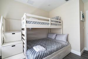 a small bedroom with bunk beds in a room at Delray Oasis: Pool, Gazebo & Beach Access in Delray Beach