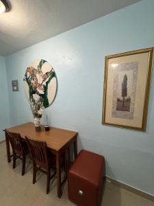 a dining room table with a vase on top of it at Studio with private entrance and bath sleeps up to 6, Unit 1 in San Juan