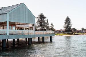 a building on a pier in the water at Beach shack! in Sydney