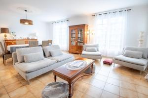 a living room with a couch and chairs and a table at Laelydi in Amboise