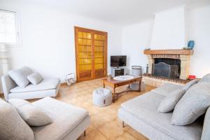 a living room with two couches and a fireplace at Laelydi in Amboise