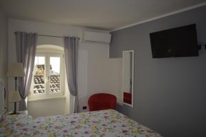 a bedroom with a bed and a window at Appartamento Anna in Brenzone sul Garda