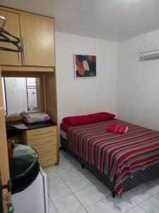 a bedroom with a bed and a dresser in it at Pousada Aconchego do Tambaú in João Pessoa