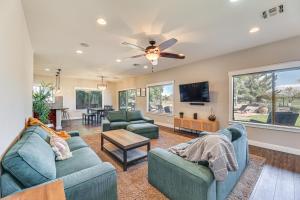 a living room with two couches and a ceiling fan at Expansive Mesa Retreat with Private Outdoor Pool! in Mesa
