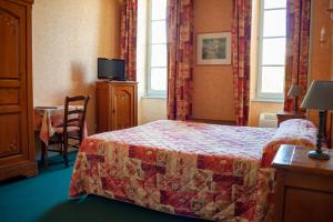 ein Hotelzimmer mit einem Bett, einem Tisch und einem Fenster in der Unterkunft L'Hotel du Nord - Quarré-les-Tombes in Quarré-les-Tombes