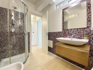 a bathroom with a sink and a shower at Guendalina in Santa Teresa Gallura +11 photos