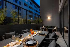 a table with plates of food on a balcony at Win Herastrau - Luxury Design 2BR Apartment - Parking in Bucharest