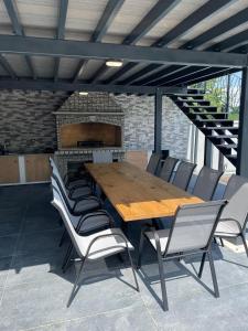 a wooden table and chairs in front of a brick fireplace at Villa Luana in Ludbreg