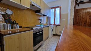 a kitchen with a stove and a counter top at Borno Good Stay! in Borno