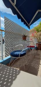 a patio with two chairs and an umbrella at Art Deco Apartment in Athens