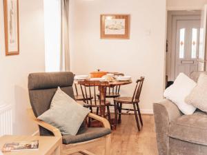 a living room with a table and chairs at Chalkhill View - Idyllic Sea Views Parking in Wyke Regis