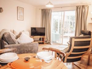 a living room with a couch and a table at Chalkhill View - Idyllic Sea Views Parking in Wyke Regis