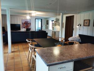 a kitchen and living room with a table and chairs at (id075) Ø. Tovrupvej 1 in Esbjerg