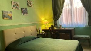 a bedroom with a bed and a desk and a desk at Hotel Roma in Bologna