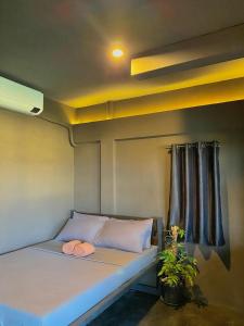 a bed with two towels on it in a room at Mojo Hostel in Puerto Princesa City +33 photos