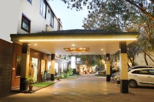 a building with a car parked in front of it at The Byke Grassfield Resort with Outdoor Pool, Shyam Nagar, Jaipur in Jaipur
