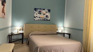 a bedroom with a bed and two side tables at Hotel Roma in Bologna