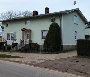 a white house with a staircase in front of it at Labahn in Lohme +7 photos