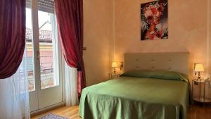 a bedroom with a bed and a window at Hotel Roma in Bologna