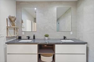 a bathroom with two sinks and a large mirror at Modern Luxurious Dream Home Mar Vista, 4BDRMs, 4Baths, Kid & Pet Friendly, 10min to the beach!! in Los Angeles
