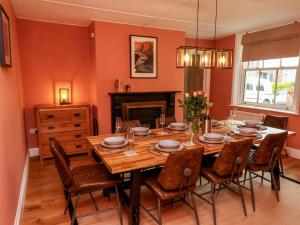 a dining room with a table and chairs and a fireplace at Laurel House in Whitby
