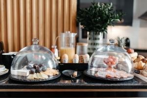 two glass domes on top of a counter with food at Cape Finest Guest House located in De Waterkant in Cape Town