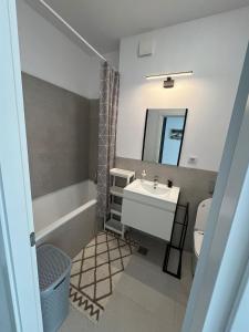 uma casa de banho com um lavatório, um WC e um espelho. em Fancy apartament Silk district em Iaşi