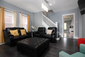 a living room with two chairs and a couch at The Texas Hold-em Duplex- 3BR Free Parking, Minutes From Falls & Casino in Niagara Falls