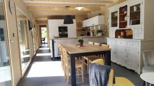 a kitchen with a table and chairs in a room at Gîte Le Charme d'Argent in Charmois-devant-Bruyères