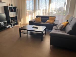 a living room with a couch and a coffee table at Apartamento con vistas in Roquetas de Mar