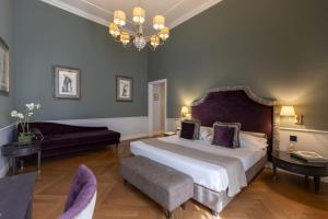 Postel nebo postele na pokoji v ubytování Palazzo Roselli Cecconi