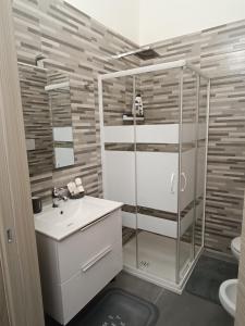 een badkamer met een douche, een wastafel en een toilet bij Storm Sonic House in Palo del Colle