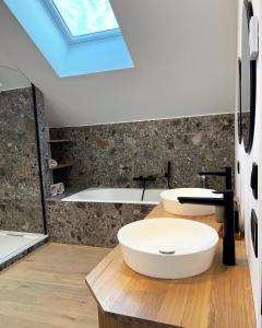 a bathroom with two sinks and a skylight at Gite Mameye in Tellin +27 photos