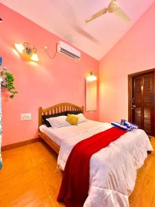 a bedroom with a large bed with red walls at Mount View Villa - The Dream Stays ll Pvt Pool ll Garden ll 3Ac rooms in Lonavala +42 photos