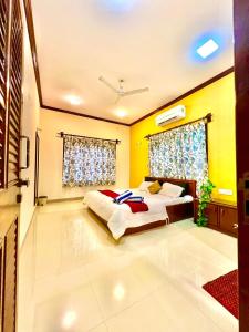 - une chambre avec un lit et un mur jaune dans l'établissement Mount View Villa, à Lonavala