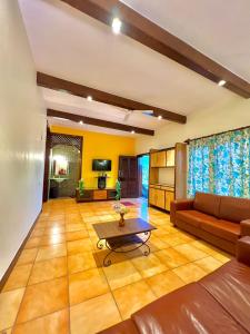 a living room with a couch and a table at Mount View Villa in Lonavala