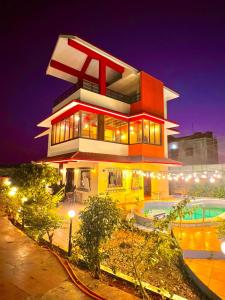 a large house with a pool in front of it at Mount View Villa in Lonavala
