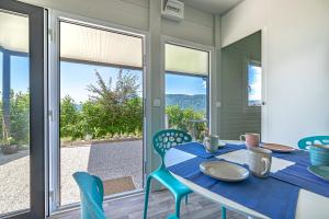 a dining room with a blue table and chairs at Happy House Of Nature in Šmartno ob Paki