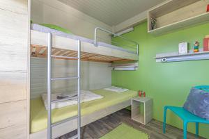 Etagenbett in einem Zimmer mit grünen Wänden in der Unterkunft Happy House Of Nature in Šmartno ob Paki