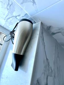 a hairdryer hanging from a wall in a room at Private double room in the center of london in London