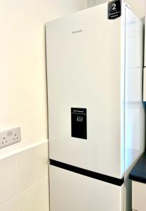 a white refrigerator freezer sitting in a kitchen at Private double room in the center of london in London