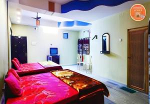 a bedroom with a red bed in a room at Hotel Parteek Residency Near Amrabati Park - Bypass Road Digha in Digha