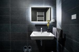 a bathroom with a white sink and a mirror at Blauer Stein 7a WH03 - Apartment 2 SZ, 5 Betten in Pulheim +17 photos