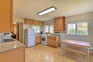 a kitchen with wooden cabinets and a white refrigerator at Parkstrip Place, Pet Friendly Downtown Home in Anchorage +68 photos