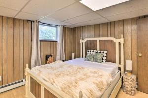a bedroom with a large bed in a room with wooden walls at Parkstrip Place, Pet Friendly Downtown Home in Anchorage