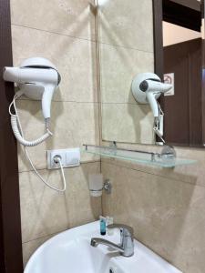 a bathroom with a sink and a mirror at Shushabandi Kazbegi in Stepantsminda