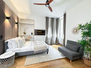 a bedroom with a bed and a couch and a ceiling fan at 2063 - Orsay studio in Paris Olympic Games 2024 in Paris