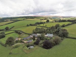 an aerial view of a house in a green field at Dunkery Cottage Wheddon Cross in Minehead