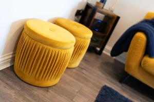 two wooden stools sitting in a living room at Dockside in Dundee