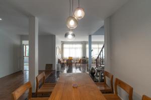 a dining room with a wooden table and chairs at 清迈古城柚子别墅塔佩门里 in Chiang Mai